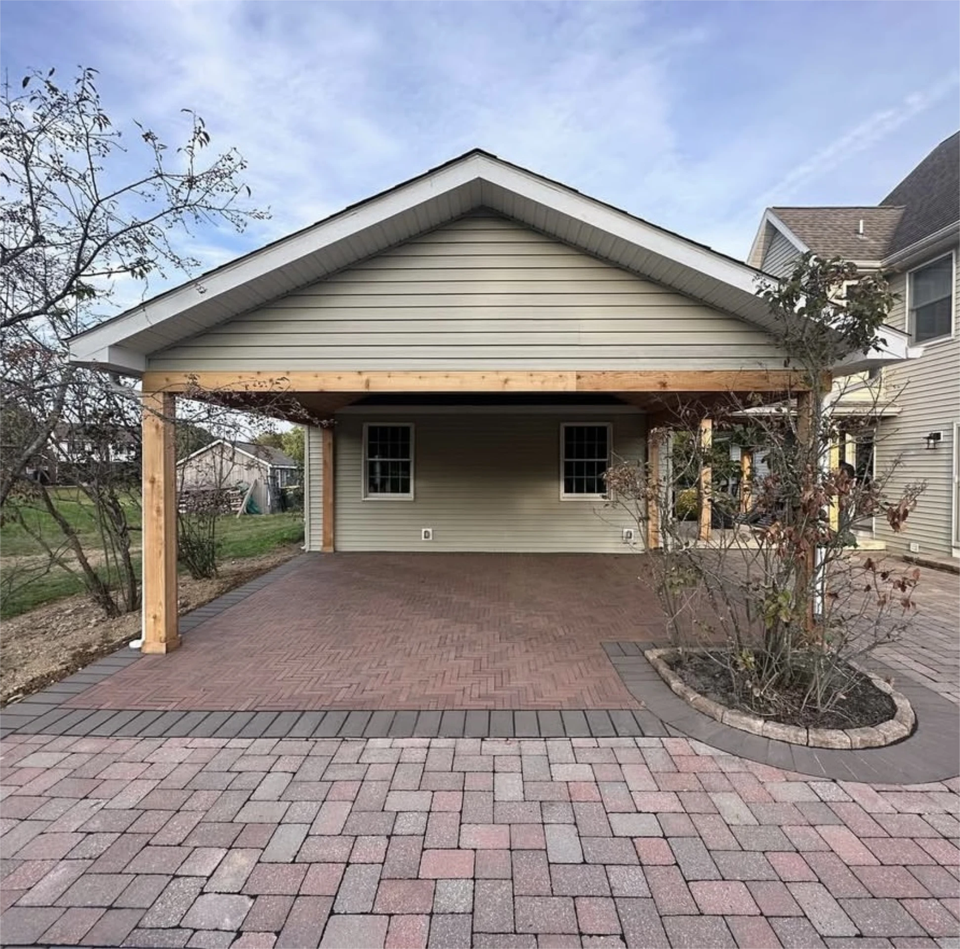 Front view of covered patio with gable roof and paver patio.