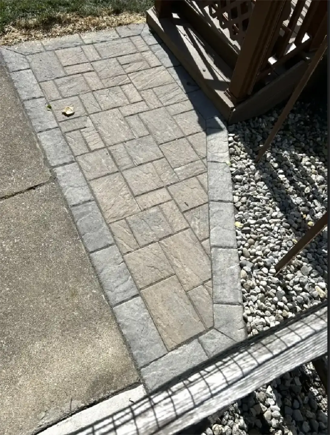 Gray stone paver walkway with dark border edging.