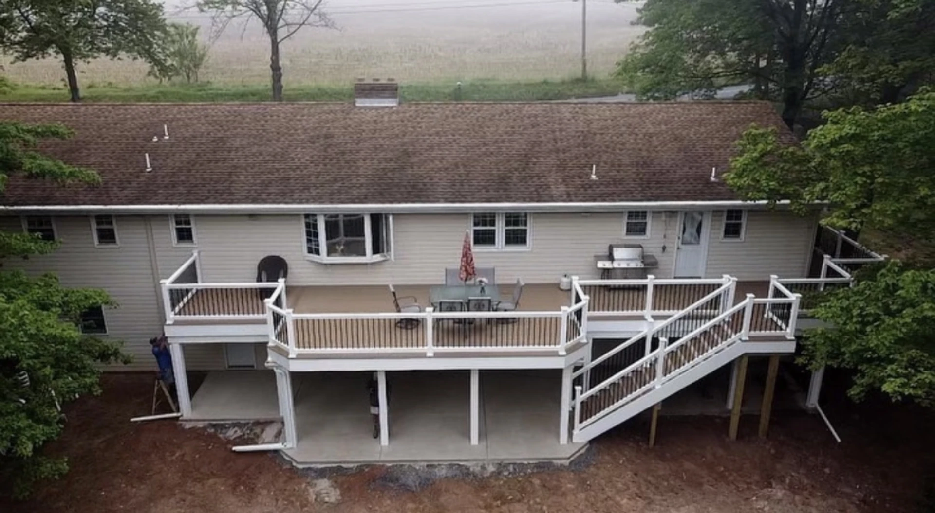 Large raised backyard deck with multiple sections and staircase.