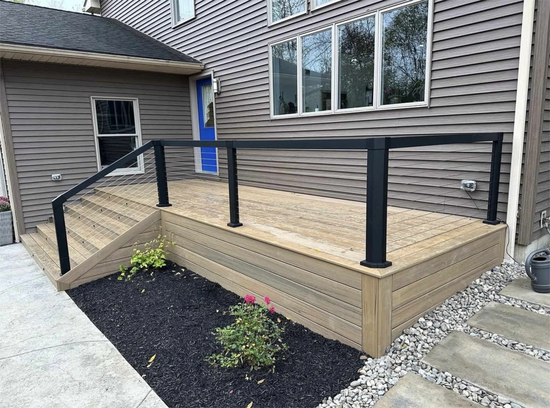 Modern backyard deck with black cable railing
