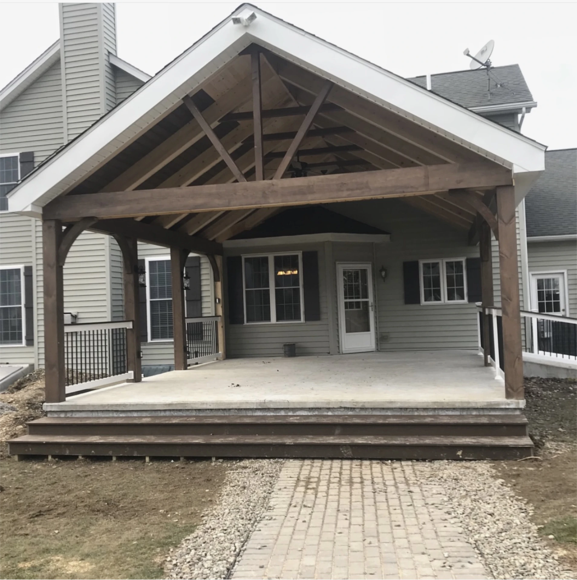 Timber pavilion over concrete patio with exposed trusses