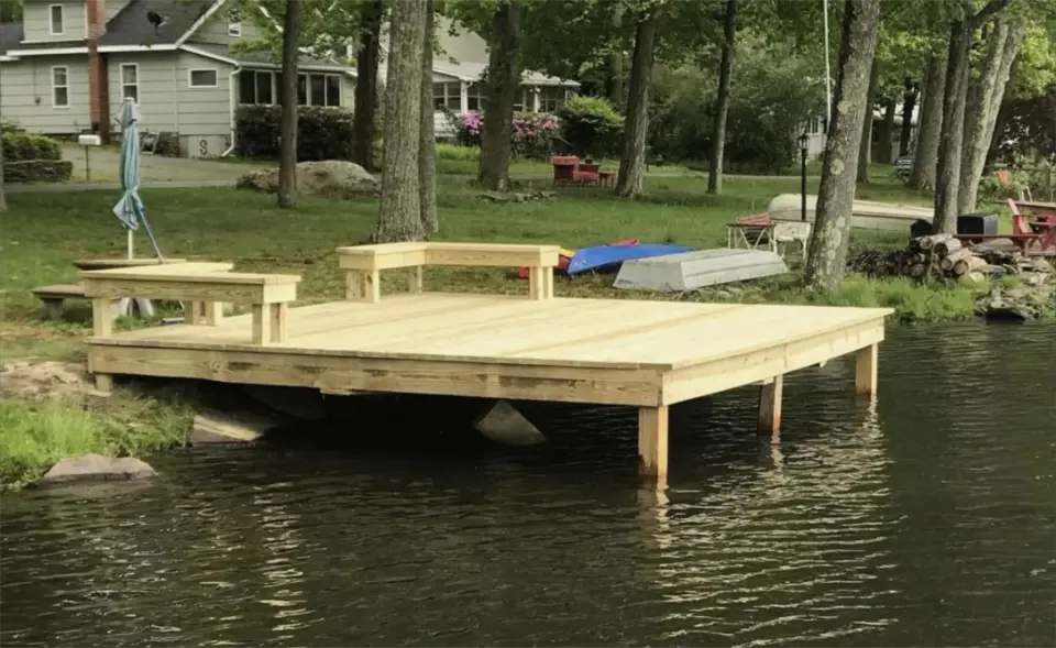 Wooden lakeside dock with bench seating