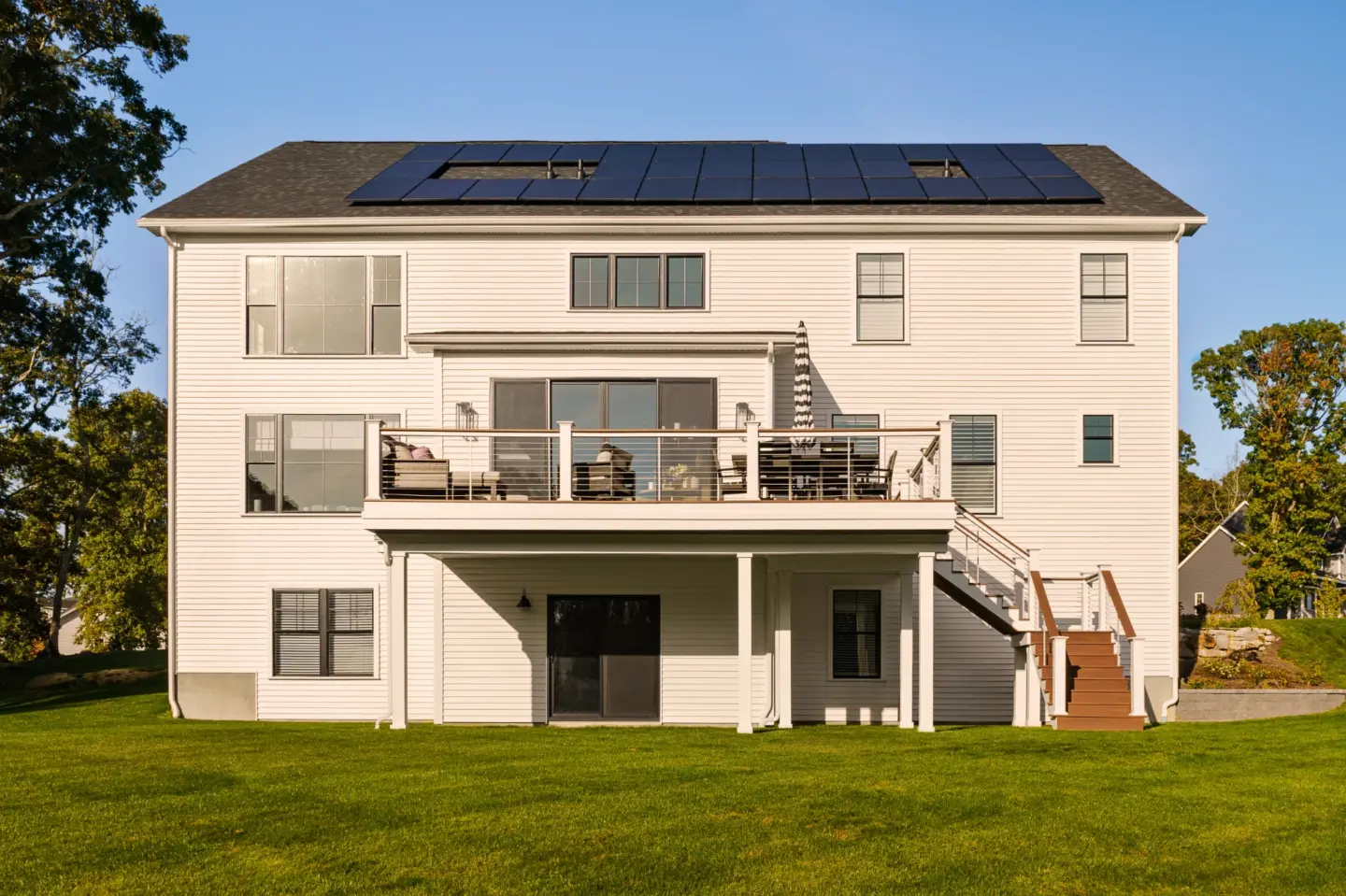 Modern house with solar panels and deck.webp