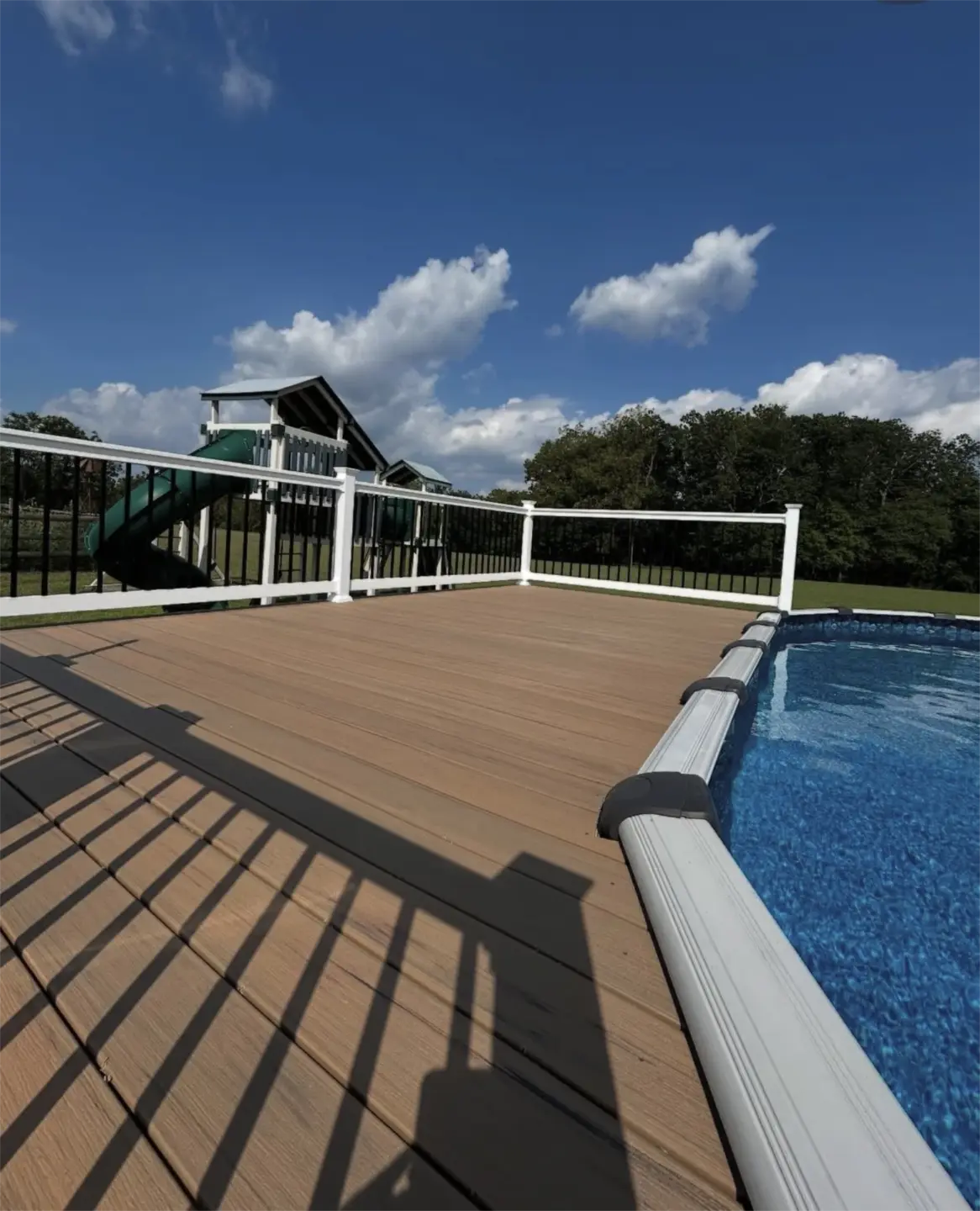 Tan composite pool deck beside above ground pool